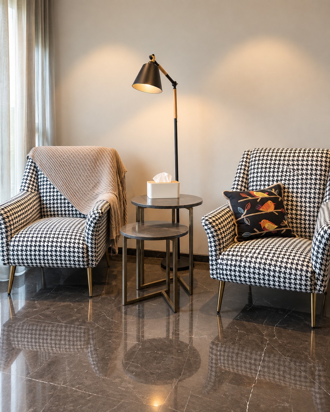 Two black and white houndstooth armchairs with nesting side tables and a floor lamp at The Ahmedabad Home – Client 103.