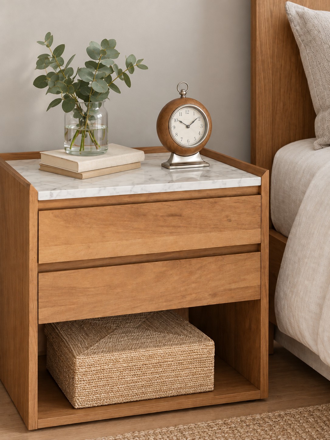 Warm wood tones meet a pale veined top in this thoughtfully proportioned bedside piece. Two drawers and an open lower shelf keep everyday essentials close at hand.