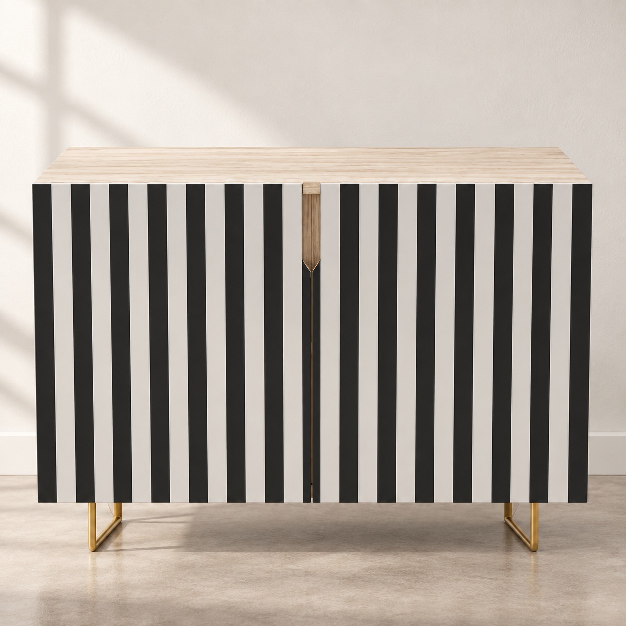 Bold vertical stripes define the doors beneath a pale wood-toned top. A narrow central detail and open gold-toned feet complete the graphic design.
