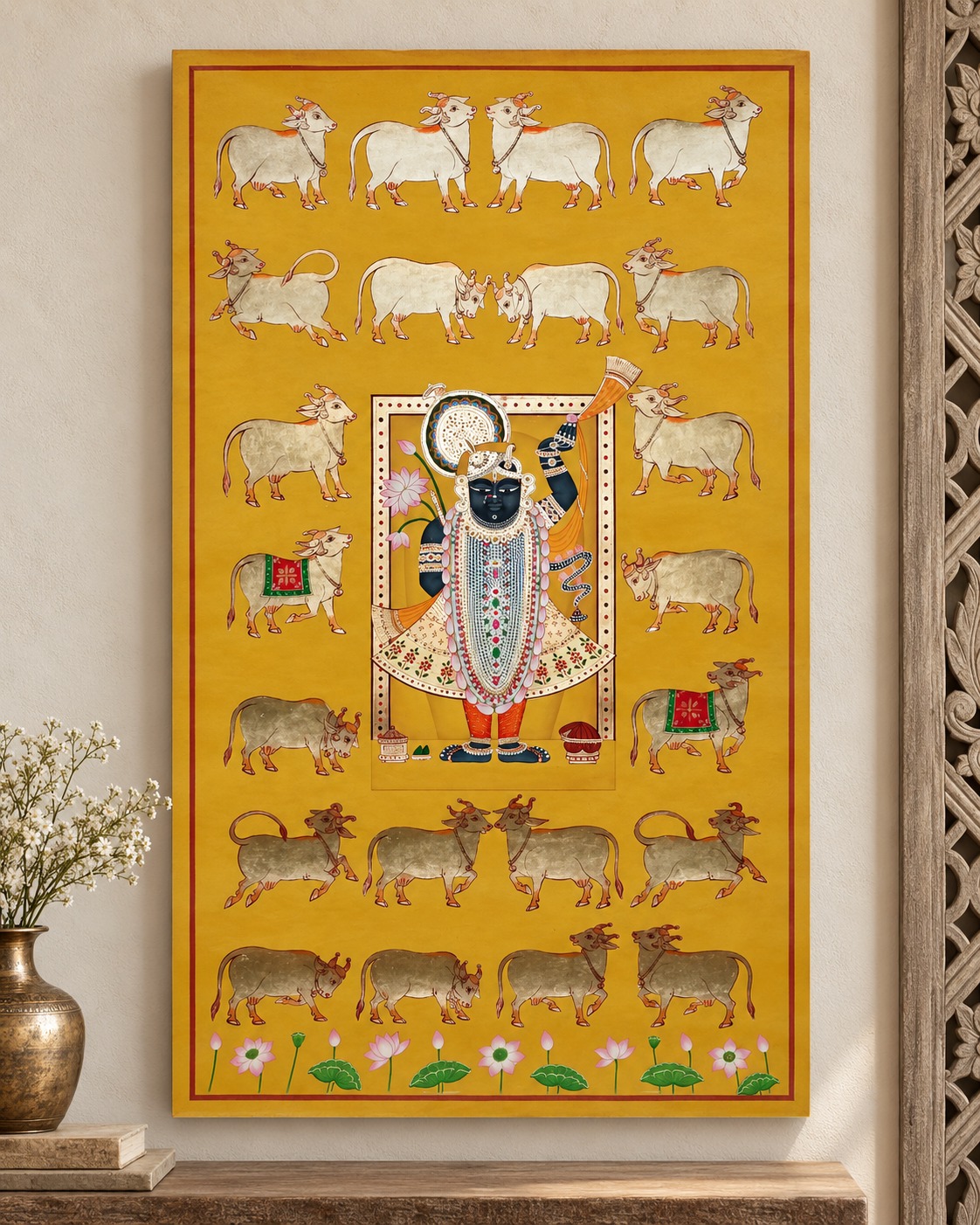 A vivid ochre artwork brings colour and intricate detail to a quiet wall. The surrounding neutral textures and a simple vessel arrangement allow the composition to take centre stage.